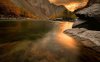 52385-burning-sunset-sky-reflected-in-the-rocky.jpg