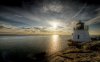 50195-small-stone-lighthouse-facing-the-sun-above-.jpg