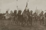 Native Americans wearing headdresses on horseback 1910.jpg